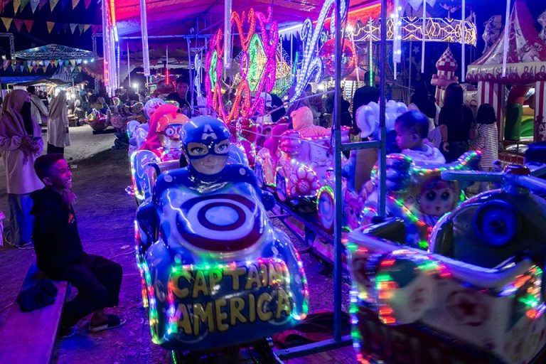 Sejumlah anak menikmati permainan di wahana permainan saat berwisata lebaran di Pasar Malam di Palu, Sulawesi Tengah, Minggu (14/4/2024).