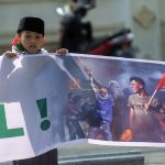 Seorang anak yang yang tergabung dalam Barisan Aliansi Resistensi Al-Aqsha (Baraq) memegang spanduk saat ikut berunjukrasa di Palu, Sulawesi Tengah, Jumat (5/4/2021). Mereka menyerukan penghentian genosida bagi rakyat Palestina, melawan zionisme internasional, dan meminta pemboikotan produk Israel dan juga pendukung genosida di Palestina. bmzIMAGES/Basri Marzuki