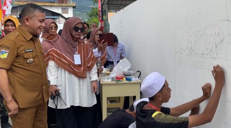 Wali Kota Palu, Hadianto Rasyid (kiri) memerhatikan pelajar membuat mural di MTs Negeri 2 Palu, Selasa (11/6/2024). (Foto: Ist)