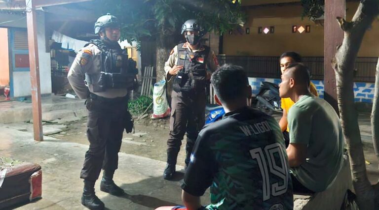 Anggota Sat Samapta Polresta Palu berbincang dengan warga saat melakukan patroli malam di kawasan pemukiman di Palu, Selasa (16/7/2024) malam. (Foto: HO-Humas Polresta Palu)