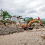 Operator alat berat membuat tanggul sementara untuk menahan abrasi di sungai di banjatan sungai Jalan Garuda, Palu, Senin (8/7/2024). (Foto: bmzIMAGES/Basri Marzuki)