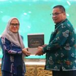Sekkot Palu, Irmayanti Pettalolo (kiri) menerima tropi dari Kepala Kantor Pajak Pratama Palu dalam Tax Gathering di Palu, Rabu (17/7/2024). (Foto: Prokopim Setda Kota Palu/Jufri)