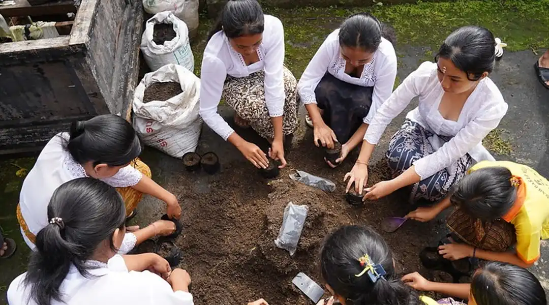 Beberapa pelajar sedang mengisi tanah subur ke dalam polybag untuk media semai salak. (©️FAO/Harriansyah)