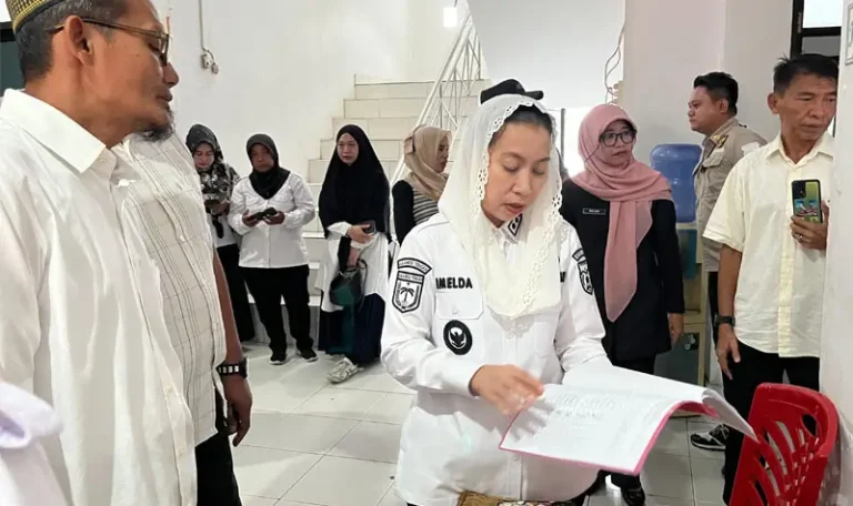 Wakil Wali Kota Palu, Imelda Liliana Muhidin mengecek daftar hadir pegawai saat melakukan sidak di salahs atu OPD di Pemkot Palu, Rabu (9/4/2025). (Foto: Prokopim Setda Kota Palu/Jufri)