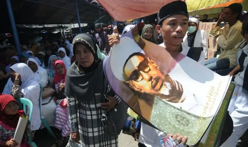 Pedagang menjajakan poster Guru Tua atau Habib Sayyid Idrus Bin Salim Al-Djufrie saat perayaan Haul (peringatan hari wafat) Guru Tua di Palu. (bmzIMAGES/Basri Marzuki)