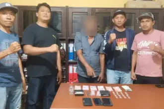 NA (tengah) bersama barang bukti sabu yang disita Polsek Parigi. Senin (8/90/2025). (©Humas Polres Parimo)