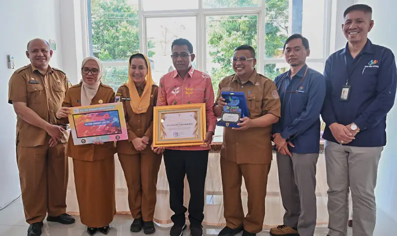 Lurah Tanamodindi (tengah) menunjukkan piagam penghargaan setelah meraih predikat terbaik Kelurahan Cantik se Sulteng dari BPS Sulteng, Senin (13/10/2025). (© bmzIMAGES/Basri Marzuki)