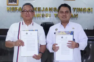 Kakanwil Ditjenpas Sulteng Bagus Kurniawan bersama Kajati Sulteng Nuzul Rahmat menunjukkan naskah pembentukan Tim Bersama Inventarisasi BMN untuk memastikan proses alih kelola Rupbasan Kelas I Palu berjalan sesuai regulasi di Palu, Selasa (11/11/2025). (©Humas Kanwil Ditjenpas Sulteng)