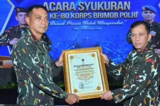 Kapolda Sulteng, Irjen Pol Endi Sutendi (kanan) menerima penghargaan dari Kakor Brimob yang diserahkan oleh Dansat Brimob Polda Sulteng, Kombes Pol. Kurniawan Tandi Rongre, Jumat (14/11/2025). (©Humas Polda Sulteng)