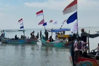 Parade perahu memperingati 16HAKtP di Dukuh Tambakpolo, Desa Purworejo, Kabupaten Demak, Minggu (30/11/2025). (©KIARA)