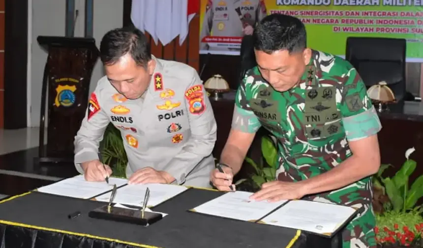 Kapolda Sulteng Irjen Pol Endi Sutendi (kiri) dan Pangdam XXIII/Palaka Wira Mayjen TNI Jonathan Binsar Parluhutan Sianipar meneken naskah PKS di Mapodla Sulteng, Jumat (19/12/2025). (©Pendam 23/Pw)