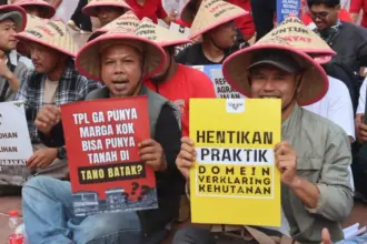 Petani dari Serikat Petani Pasundan (SPP) melakukan aksi solidaritas atas perjuangan Masyarakat Adat Tano Batak dan Gereja Huria Kristen Batak Protestan (HKBP) di Tugu Proklamasi, Jakarta, Senin (16/7/2025). (©KPA)