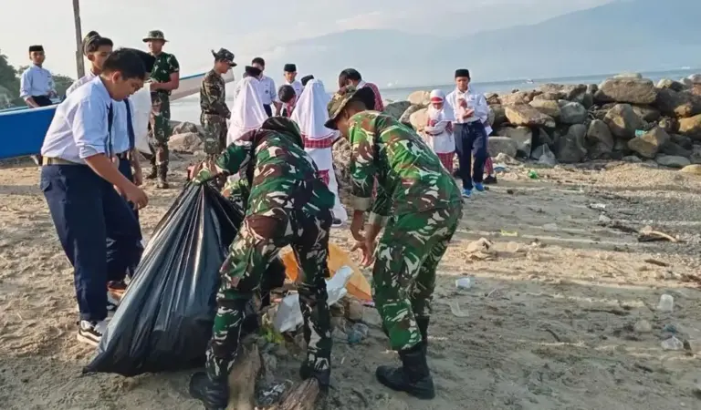Warga bersama TNI AD bergotong royong membersihkan sampah di Pantai Uesalura, Tondo, Palu, Selasa (28/1/2026). (©Kodim 1306/KP)