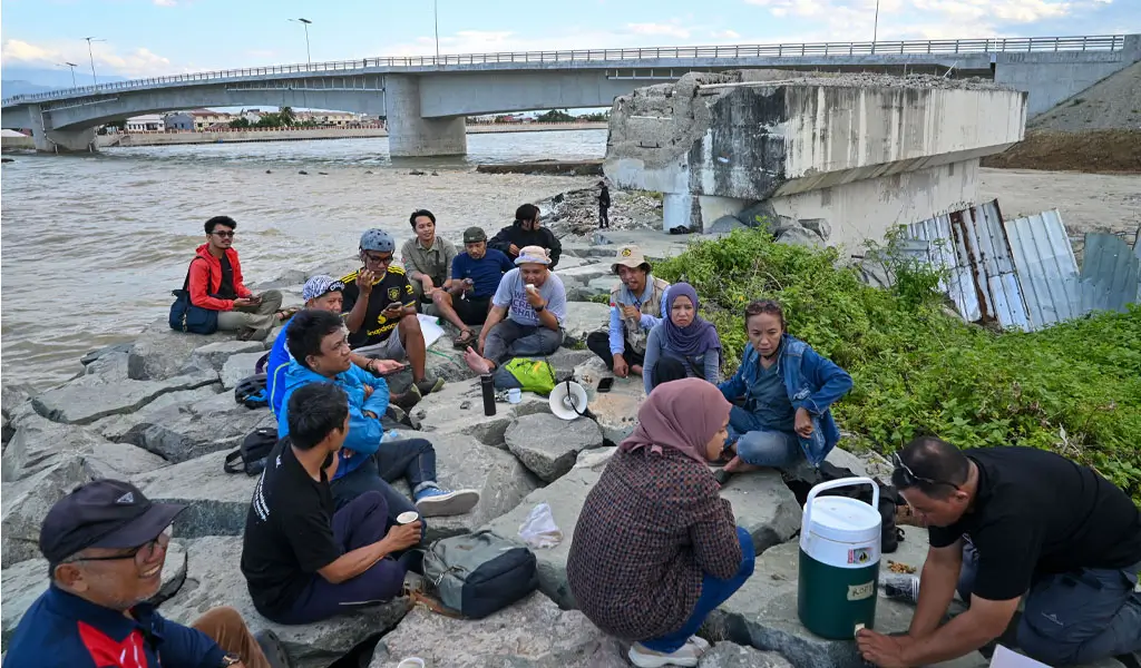Warga, komunitas dan FPRB Kota Palu berdiskusi di tanggul batu gajah yang menolak pembongkaan oprit Jembatan Palu IV dan mengusulkannya sebagai cagar budaya kebencanaan, Minggu Minggu (18/1/2026). (©bmzIMAGES/Basri Marzuki)