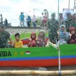 Pangdam XXIII/Palaka Wira Mayjen TNI Jonathan Binsar Parluhutan Sianipar (kedua kiri) bersama Bupati Tojo Unauna Ilham S Lawidu (kiri) menaiki perahu bersama siswa di Keupalauan Togean, Jumat (27/2/2026). (©Pendam23/PW)