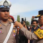 Wakapolda Brigjen Pol Dr Helmi Kwarta Kusuma Putra Rauf menyematkan pita kepada personel menandai dimualian Operasi Keselamatan Tinombala 2026 di Mapolda Sulteng, Senin (2/2/2026). (©Humas Polda Sulteng)