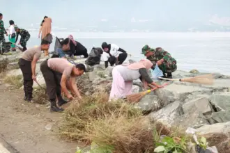 Personel gabungan aksi bersih-bersig di Pantai Kampung Nelayan, Palu, Jumat (13/2/2026). (©Humas Polresta Palu)
