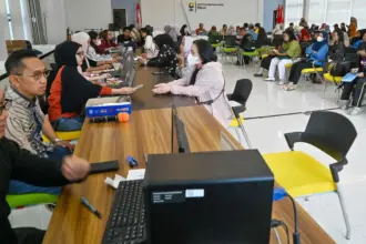 Kepala KPP Pratama Palu Tommy Yulianto (kedua kiri) bersama Kasi Pelayanan, Edy Prasetyo (kiri) turun langsung melayani wajib pajak yang akan melaporkan SPT Tahunannya di Aula KPP Pratama Palu, Jumat (27/3/2026). (©bmzIMAGES/Basri Marzuki)