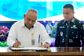 Kepala Perwakilan BPK Sulteng, I Putu Wisudhantara menekan berita acara penemaaan LKPD dari Wali Kota Palu, Hadianto Rasyid di Palu, Senin (30/3/2026). (©Prokopim Setda Kota Palu/Iwan)