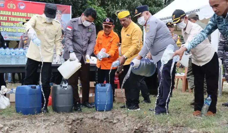 Kapolres bersama Forkopimda Parimo menunag miras ke dalam lubang pada pemusnaha miras hasil operasi pekat di parigi, Kamis (12/3/2026). (©Humas Polres Parimo)