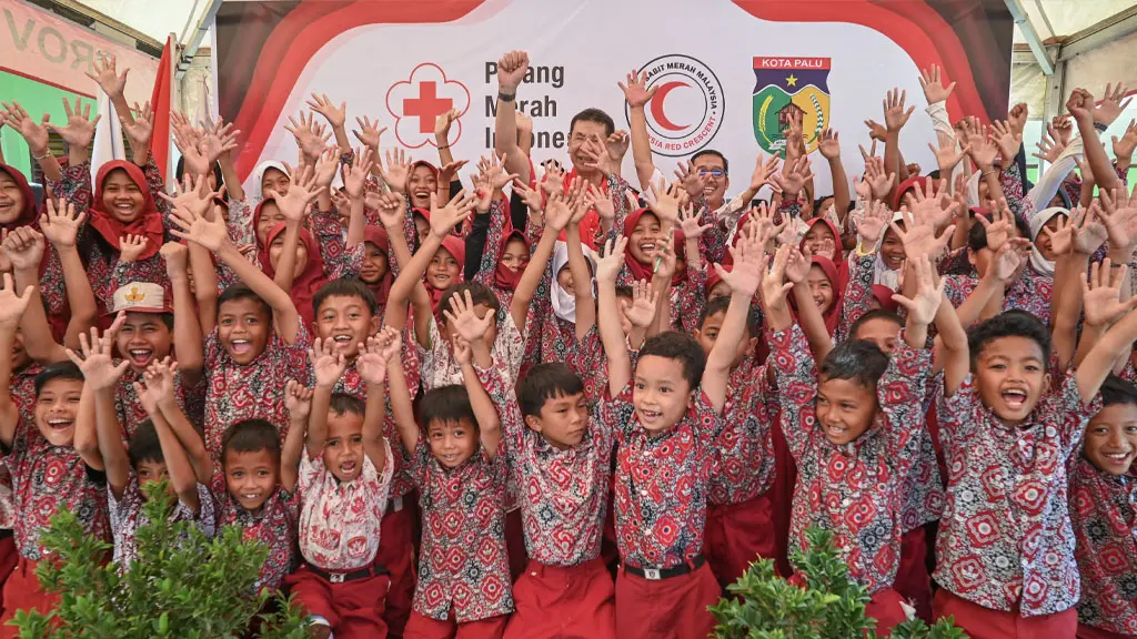 Sejumlah siswa SD Inpres 01 Lere bersama National Vice Chairman Bulan Sabit Merah Malaysia (MRCS) Dato Sri H Suhaimi bin H Yacob (tengah belakang) meneriakkan yel-yel usai penyerahan fasilitas hasil donasi MRCS, Rabu (29/4/2026). (©bmzIMAGES/Basri Marzuki)